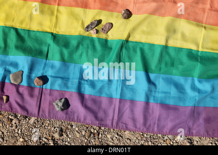 Stones lie on the rainbow flag in remembrance of homosexuals in Buchenwald concentration camp near Weimar, Germany. Stock Photo