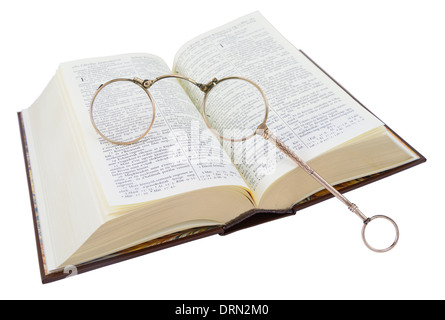 Open Hungarian book (bible) with old glasses, isolated on white. Stock Photo