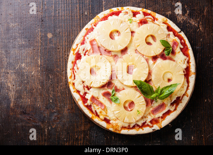 Hawaiian pizza with pineapple and ham on wooden table Stock Photo
