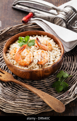 Shrimps Risotto in wooden bowl Stock Photo