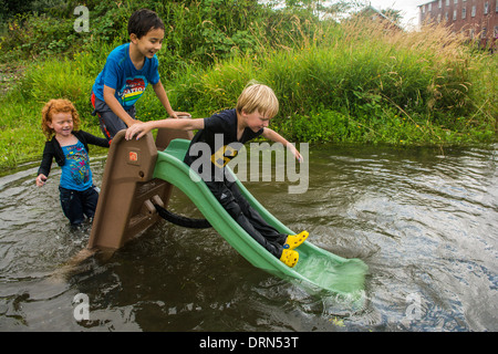 Children playing on slide in the Columbia River, Astoria, Oregon, USA Stock Photo