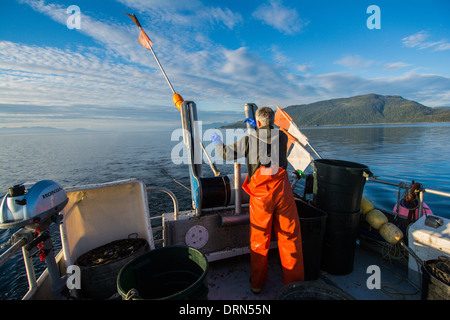 Fisherman laying out longline for Black Cod commercial fishing, Chatham Strait, Southeast Alaska, USA Stock Photo