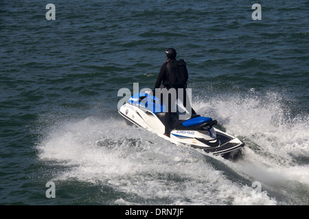 Alameda County police officer on jet ski patrolling in the San Francisco Bay, San Francisco, California, USA Stock Photo