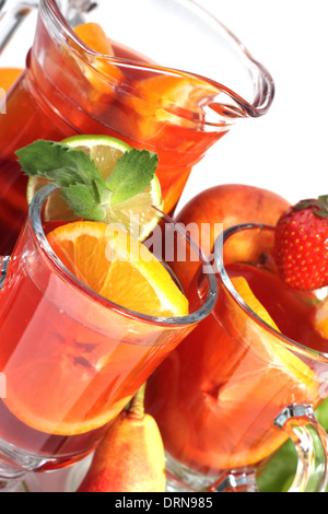 Refreshing fruit sangria in jug with different fruits solated on white Stock Photo
