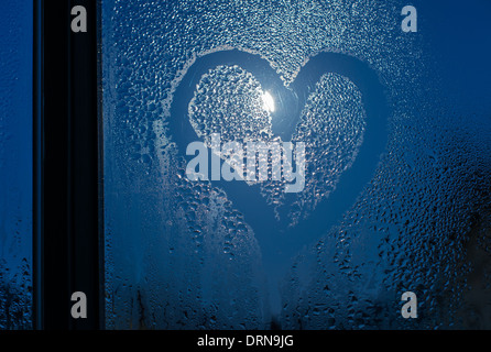 Moonlight through the window. Sweaty glass and heart shape Stock Photo