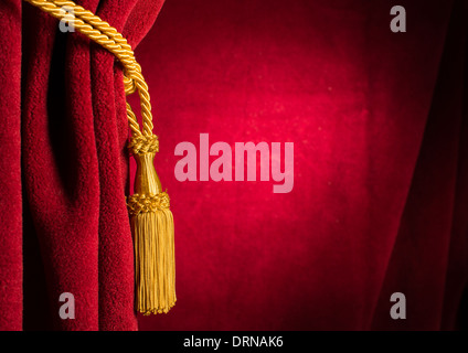 Red theatre curtain and yellow tassels Stock Photo