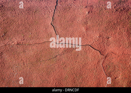 Cracked red plaster on a wall. Stock Photo