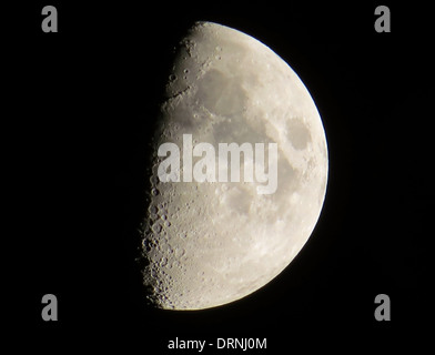 Half moon with right side illuminated against a black night sky taken from Braunton in North Devon England UK Stock Photo