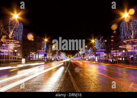 Decorated Champs-Elysees street with light trails at night in Paris, France Stock Photo