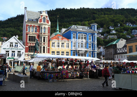 The market stalls of street vendors selling souvenirs on Nedre Vågsallmenningen in Bergen city, Norway, in front of historical buildings. Stock Photo