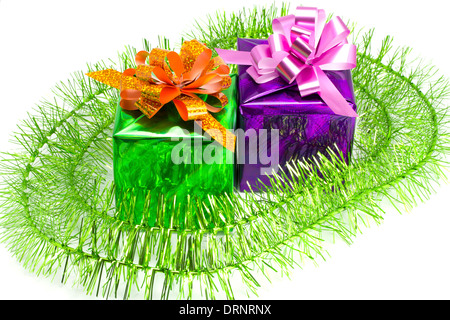 Green and violet gift with a tinsel on the white isolated background Stock Photo