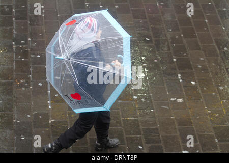 London UK. 30th January 2014. A young child walks with a large see through umbrella as the rain conditions continue to affect the capital and many part of the United Kingdom Credit:  amer ghazzal/Alamy Live News Stock Photo