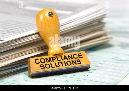 compliance solutions marked on rubber stamp Stock Photo