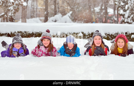 Group of children playing on snow in winter time Stock Photo