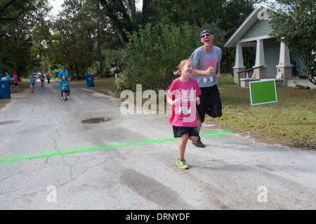 Crossing finish line at Crossroads Pregnancy Center annual 5K walk / run charity race in High Springs, Florida. Stock Photo