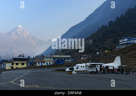 Passengers boarding a plane at Nepal's Lukla airport Stock Photo