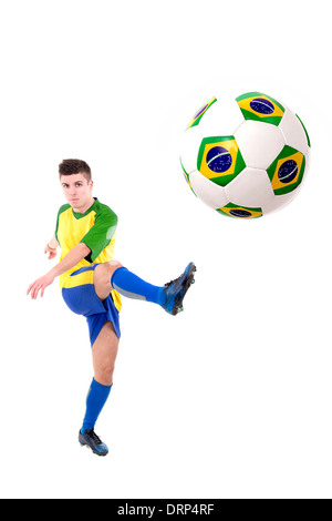 Football player kicking a ball isolated in white Stock Photo