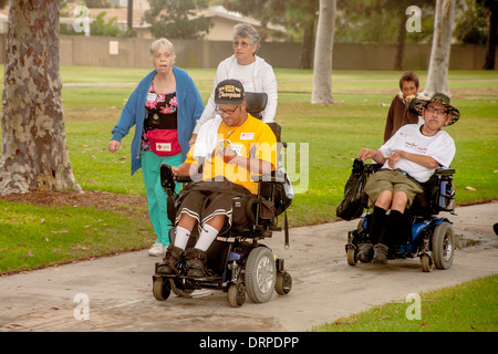 Men in wheelchairs join a fund raising walk in Costa Mesa, CA, for Project Independence, an advocacy group for the handicapped. Stock Photo