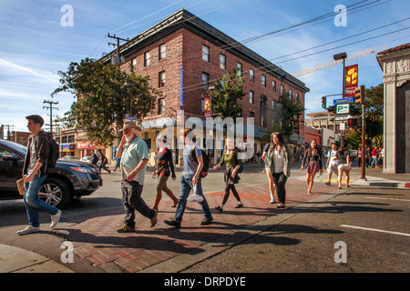 Multiracial University of California students and older locals walk across Durant Avenue in Berkeley, CA. Stock Photo