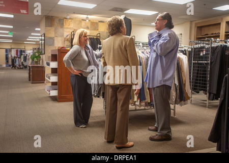 An unemployed Hispanic man proudly gets new business clothing from Working Wardrobes, a organization helping the unemployed. MR Stock Photo