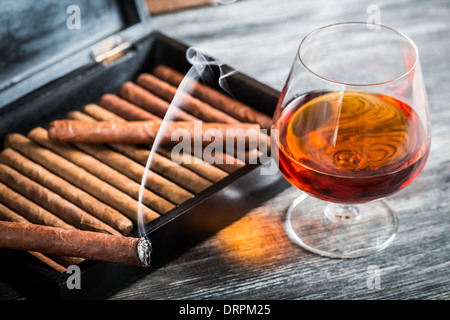 Cigars in humidor and cognac Stock Photo