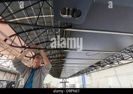 Duebendorf, Switzerland. , 29 Jan 2014: An engineer of the Solar Impulse project team is working on the wiring of the 17'000 solar cells that cover the 72m wide wing of the'Solar Impulse 2' (HB-SIB) solar powered aircraft that is built in a hangar in Duebendorf, Switzerland. . Swiss aviation pioneer Bertrand Piccard is planning to fly the futuristic solar powered aircraft around the world in 2015. Credit:  Erik Tham/Alamy Live News Stock Photo