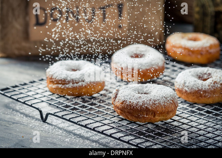 Falling powder sugar on donuts Stock Photo