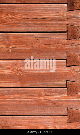 Corner of wood house with striped red wooden panels Stock Photo