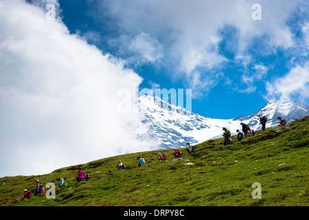 Japanese tourists on walking trail by the Eiger and Jungfrau mountains in the Swiss Alps, Bernese Oberland, Switzerland Stock Photo