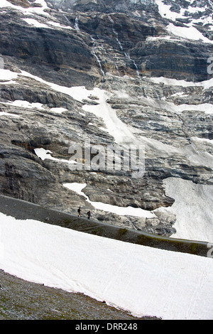 Hikers on the Eiger Trail near the Eiger Glacier, Eigergletscher, in Swiss Alps, Bernese Oberland, Switzerland Stock Photo