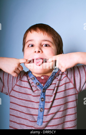 Young notorious boy making a teasing face Stock Photo