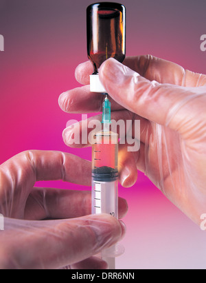 Doctor filling syringe Stock Photo