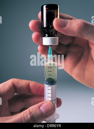 Doctor filling syringe Stock Photo