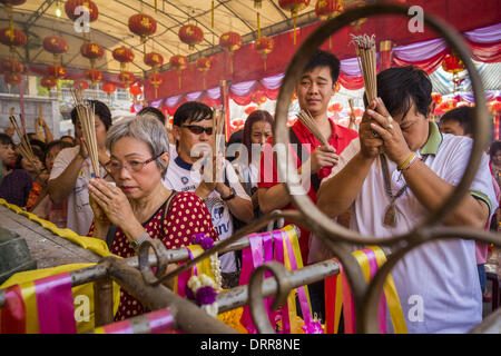 Bangkok, Thailand. 31st Jan, 2014. People pray at Wat Mangkon Kamalawat during Lunar New Year festivities, also know as Tet and Chinese New Year. This year is the Year of the Horse. Credit:  Jack Kurtz/ZUMAPRESS.com/Alamy Live News Stock Photo
