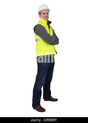 Full-length portrait of engineer with hard hat and yellow reflective safety vest Stock Photo