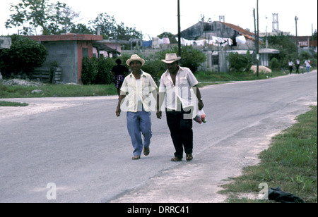 Men walking along residential street in Cozumel, Mexico Stock Photo