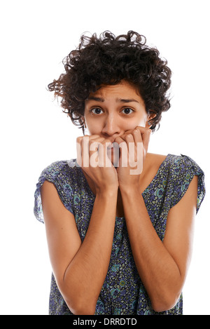 portrait of worried and stressed hispanic girl biting nails and looking at camera on white background Stock Photo