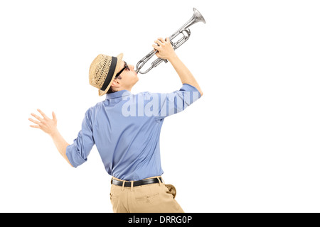 Excited young musician playing trumpet Stock Photo