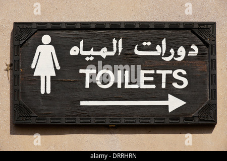 Sign for women's toilets in Arabic and English, Dubai, UAE Stock Photo