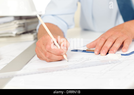 Working on blueprints and construction plans Stock Photo