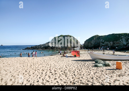 peaceful beach scene on hot Christmas day as Mexican families from neighboring towns enjoy cooling off in sea at San Agustinillo Stock Photo