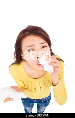 Sneezing and blowing nose, young woman struggles with cold Stock Photo