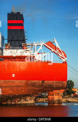 A lifeboat on the rear of a cargo ship. Stock Photo