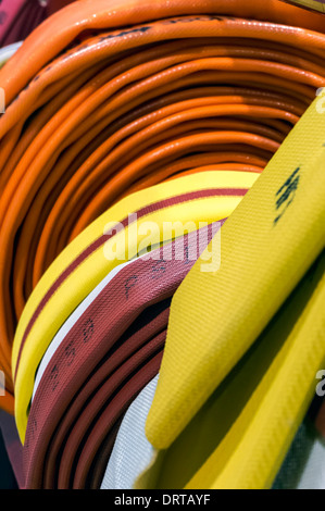 Coiled fire hoses display at trade show. Stock Photo