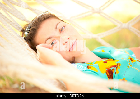 beautiful girl relaxes in a hammock Stock Photo