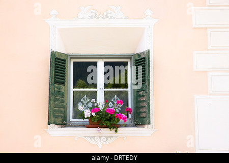 Detail of window in the Engadine Valley in village of Guarda with old painted stone 17th Century houses, Switzerland Stock Photo