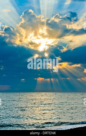 A vertical shot of a beautiful bright sunset sky over a blue sea Stock ...