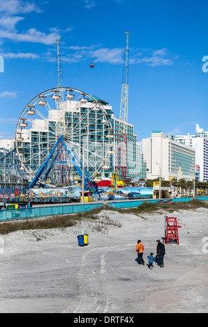 Ferris wheel and roller coaster in the Daytona Beach boardwalk amusement park on the beach. Stock Photo