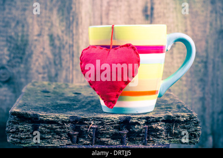 Heart hung on a colored cup Stock Photo