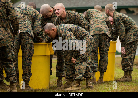 US Marine recruits choke and gasp for air after exiting the gas chamber during boo camp January 13, 2014 in Parris Island, SC. Stock Photo